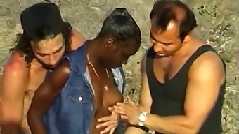 African-American Lady Enjoys A Threesome With Two Caucasian Gentlemen By The Ocean