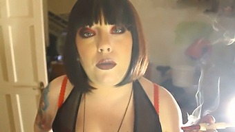 Domme Tina Smua Smokes A Cigarette In A Holder While Wearing Latex